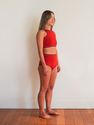 Our Naluka matching set of 2mm wetsuit top and short in red for women